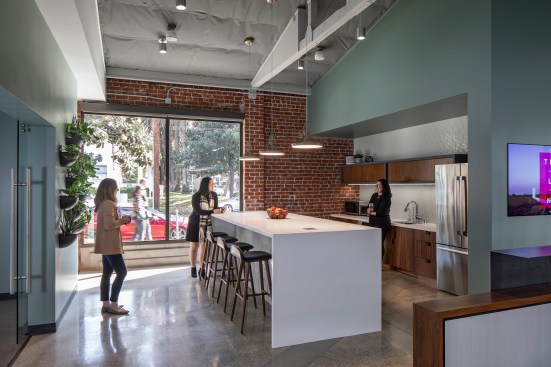 In the kitchen, a “big table” serves as the staff break area and also a pre-function prep space for events and regular AIA Executive Committee meetings.