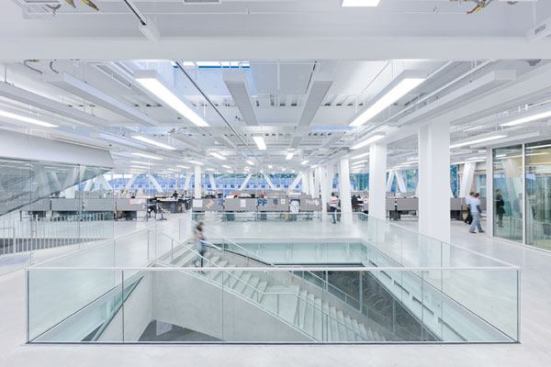 The studio space has an abundance of natural light  from three exposure of full height glazing and 41 skylights. Custom six-lamp  indirect-direct pendants were designed to mimic the form of the chilled beams.  The fixtures are controlled by photosensors.