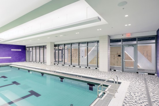 2-hour, low-iron fire resistive glass and framing provide light and openness while maintaining fire rated code requirements between the pool and 2 hour exit corridor.