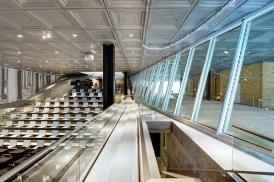 The auditorium on the west side of the building is surrounded by glass on three sides. Halogen ellipsoidal downlights, with the same diameter aperture as the downlights over the pedestrian plaza were used due to the tall ceiling height.