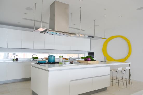 The all-white space and the 9-foot ceilings help disperse light throughout the main living area.