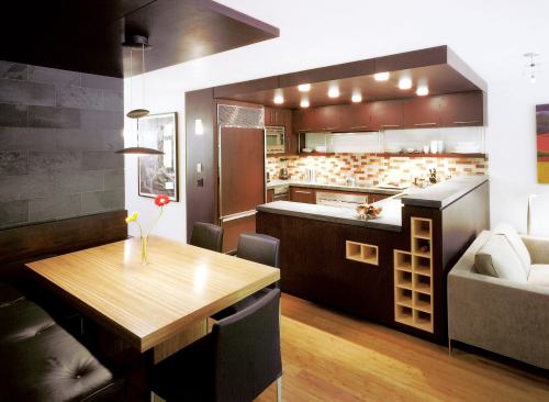 Custom Home, September-October 2004  K+B Studio  Custom Kitchen, Aspen, Colo.  Studio B Architects, Aspen Mahogany enclosures create defined areas for both the kitchen and a snug dinette. Studio B Architects found space for wine cubbies inside the half-walls separating the kitchen from the main living areas.