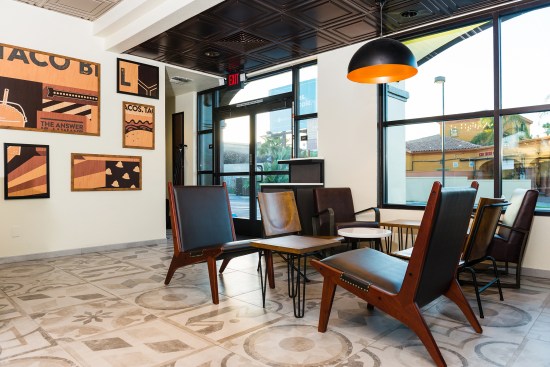 Taco Bell’s new Heritage design has warm white walls, heavy timbers, and coffered ceilings made with Ceilume’s Stratford panels.