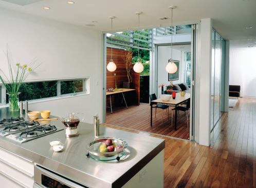 Custom Home, March-April 2009  Kitchen & Bath Design Guide  Custom Kitchen, Los Angeles  lee + mundwiler architects, Los Angeles The room’s horizontal window preserves privacy while still allowing cross-ventilation. A custom stainless steel counter tops the island.