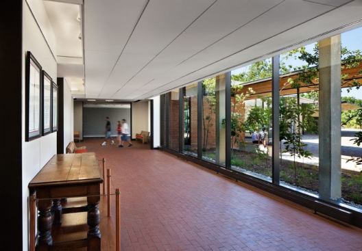 In the hallways, inward-facing fluorescent  covelights balance the outward glow of light. Concealed tracklighting is  designed to highlight student art and historical displays.
