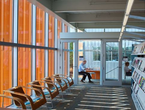 Copper-colored exterior vertical fins help to modulate the amount of natural light entering the interior.