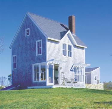 This Block Island, R.I., vacation house takes its muted color palette from the surrounding environment. Crisp white trim helps pull the composition together.