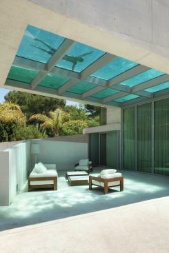 Patio shaded by the cantilevered swimming pool