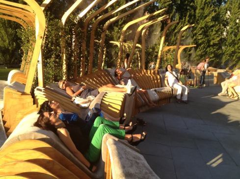 Vertical elements support a trellis from vines that provide shade, and misters that cool the visitors sitting below.