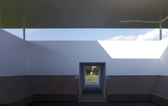 The skyspace incorporates two seating levels; concrete benches line the upper viewing area.