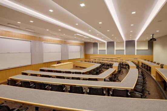 In the distance learning lecture hall the ceiling and walls are illuminated by 20W LED downlights and 7.6W LED covelights. Recessed 54W T5HO fluorescent wallwashers at the lectern have full range preset dimming. The combination provides 30 footcandles at the work surface.