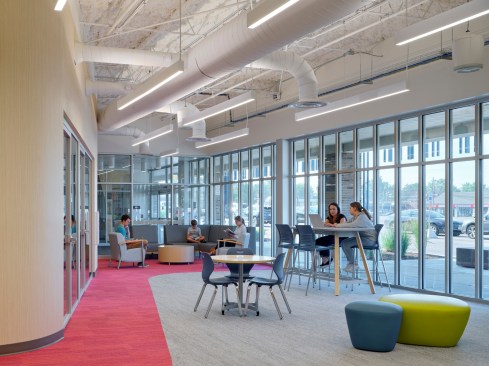 Big new windows brighten up a formerly dark retail store and bring ample daylight into the library.