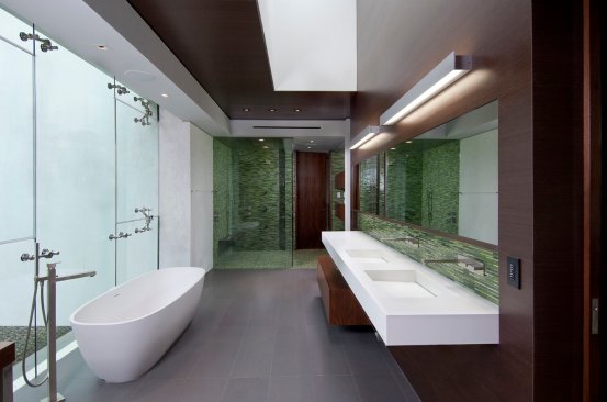 Modern luxury bathroom with skylight and soaking tub.