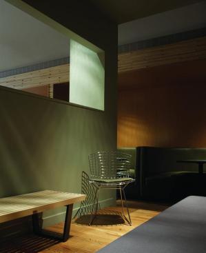A secluded area at the back of the lounge provides seating for a small group adjacent to the booths that were reclaimed from the original Tiny Lounge.