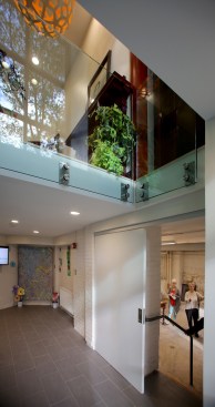 Level pavement and grass steps make an outdoor classroom surrounding the entrance and connecting to Veterans Park