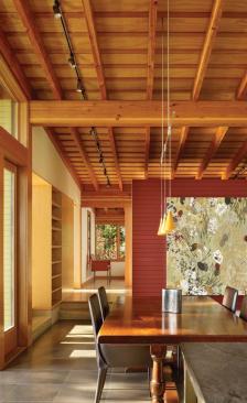 Dark red paneling in the dining area provides a punch of vibrant color.