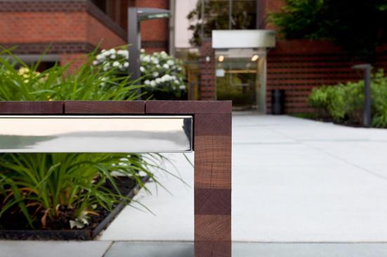 Duo Bench shown with Polished Stainless Steel frame and FSC 100% Jatoba hardwood slats and end at 80 Williams Street, Wellesley, Massachusetts