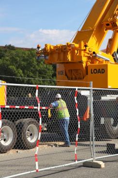 Construction workers and equipment on site.