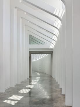 An interior corridor receives a similiar ribbed treatment to that of the exterior walkways. 