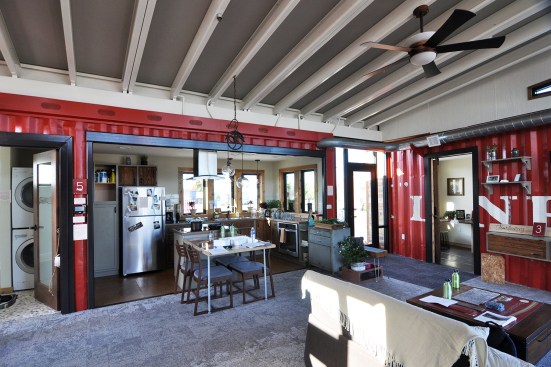 Missouri University of Science and Technology's Nest Home is not your typical shipping container house: Clad on the exterior in wood reclaimed from shipping pallets, the house reveals its character inside with containers configured in a non-orthogonal arrangement to create intimate spaces around a central living room.