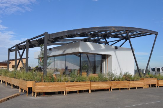 Team West Virginia/Rome entered STILE House (Sustainable Technologies Integrated in a Learning Experience) to the 2015 Solar Decathlon, with photovoltaic panels arranged on a steel arched canopy that shades the living quarters below it.