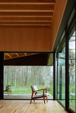 Wood flooring in the living area and elsewhere comes from on-site ash trees killed by pests, milled locally, and finished with Bona Naturale.