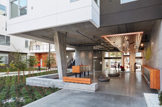 A covered open-air lobby on the ground floor contains mailboxes.