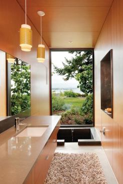 A wall of glass at the sunken concrete soaking tub presents a vista of the Seattle skyline.