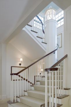 The stair rises through the tower, wrapping around a monumental lantern column.