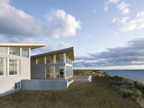 EcoHome Design Awards, Summer 2010  Grand Award  ZeroEnergy Design   Sun, sea, and family gatherings draw 20-plus lucky folks to this striking home overlooking Cape Cod Bay. Those appealing elements also presented the biggest challenges for architect Stephanie Horowitz and designer Ben Uyeda of ZeroEnergy Design. “Extreme fluctuation in occupancy was the starting point for our entire design,” Horowitz explains.Architecturally, a stand-alone foyer pushes apart the plan’s two distinct volumes and provides a physical barrier that allows the six-bedroom “sleeping bar” to be shut down most of the year. &nbsp;