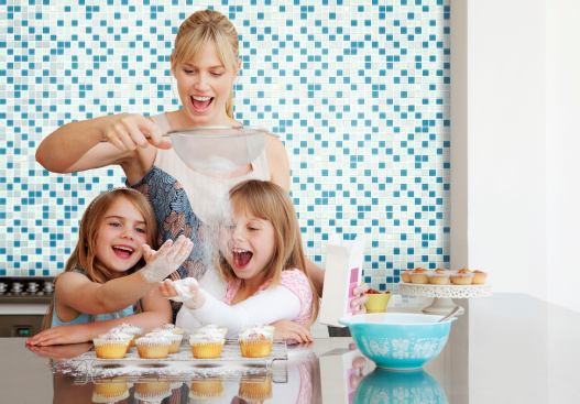 Two girls and a mum baking --- Image by © Fiona Jackson-Downes and Dirk Lindner/cultura/Corbis