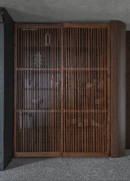 the bookcase with sliding walnut shutters