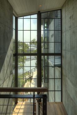 Steel-framed windows form the home’s connective tissue, capturing pastoral scenery and natural light in between the concrete walls.