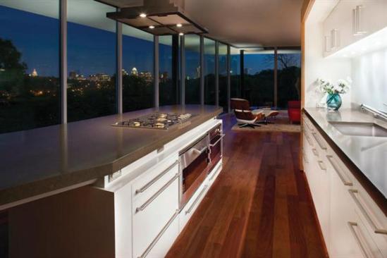 A view of kitchen looking toward the living room and skyline beyond.