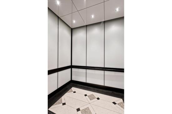 LEVELe-105 Elevator Interior with main panels in ViviChrome Chromis glass with White interlayer and Opalex finish; handrail panels in Fused Graphite with Sandstone finish; Round Handrails in Oil-Rubbed Bronze at the Brandywine Building, Wilmington, Delaware