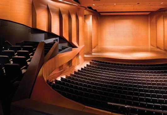 When the panels at the back of the stage are closed, a grid of perforations is evident. Not only do these perforations form a decorative pattern, they also allow sound to be absorbed and modulated by the backing acoustic material during certain types of performances and stage configurations.