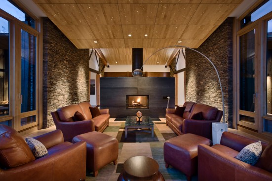 Interior, horizontal, living room toward fireplace at twilight with fiber optic stars in ceiling, Kahlbetzer residence, Wilson, Wyoming; Ward + Blake Architects