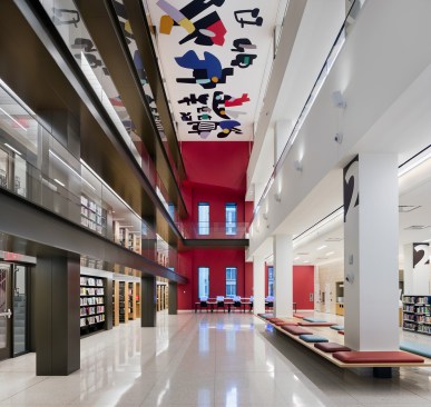 The Long Room’s atrium wall at the southern end is deep red, and perforated with new windows to bring light from a pocket park to the south. Its distinctive look assists wayfinding.
