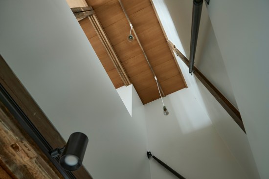 Double height connecting kitchen and bathroom
