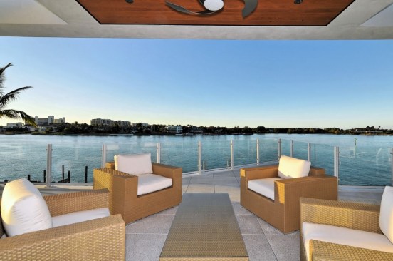 Second story bridge connects the main house to the guest house and garages below.