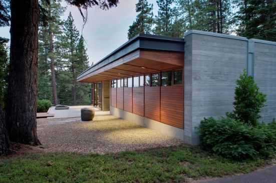 The studio entrance. Each structure contains a single floor-to-ceiling glazed room and storage components in clerestoried adjacent areas.