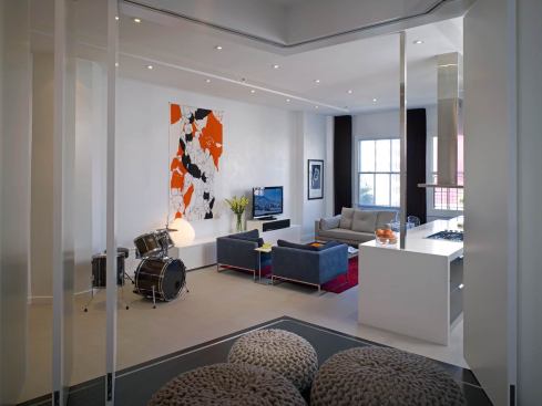 Fashionable bean bags conceal a trap door in the guest bedroom floor with a hydraulic bed inside.