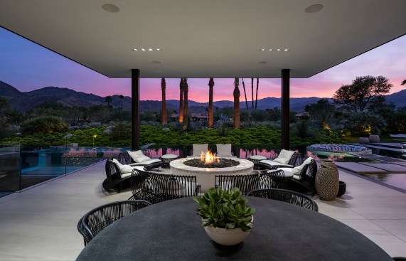 Serenity Indian Wells luxury desert home outdoor terrace dining lounge with modern firepit