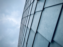 Working closely with RAC, Roofing Solutions fabricated and installed the zinc flat-lock wall tiles on all three buildings using more than 81,400 pounds of RHEINZINK prePATINA blue-grey as supplied by Oakland Metal Sales.