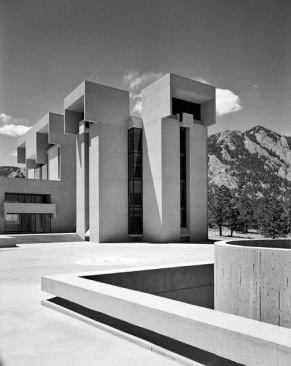 An outdoor terrace connecting the masses of NCAR, with the Rocky Mountains in the background.