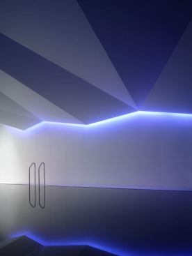 Color-variable LEDs at the ceiling perimeter were programmed to create a dramatic look with a deep red color then dimmed so that the effect is minimized to a striking zig-zag line of light. This way the ceiling is expressed without overpowering the wash of daylight at the end wall, or the cool white LEDs at the pool edge from streaking light across the water surface.