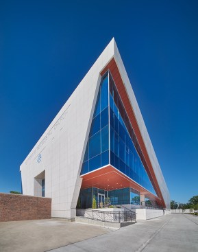 View of south elevation with entrance and dedicated parking lot.