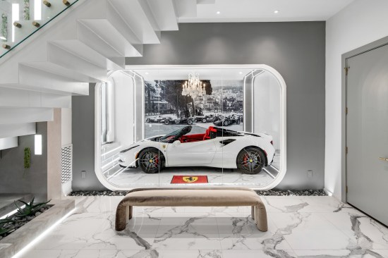 Part of the garage showcases a Ferrari to the rest of the home.