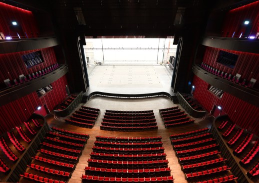 The seating is upholstered in a mixture of red and purple fabrics with a pattern of Taiwanese flowers, contrasting with the darker walls.