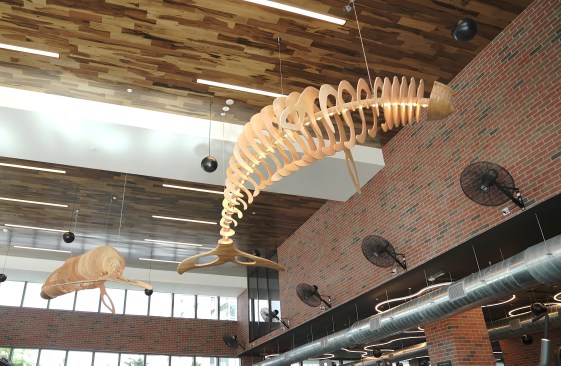 The Whale pendant is in the gym and made of wood pieces. 